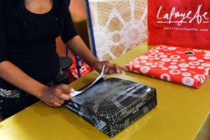 A store assistant wraps a christmas gift on December 4, 2012 at the Galeries Lafayette Paris department store, ahead of the Christmas celebrations. AFP PHOTO MIGUEL MEDINA (Photo credit should read MIGUEL MEDINA/AFP/Getty Images)