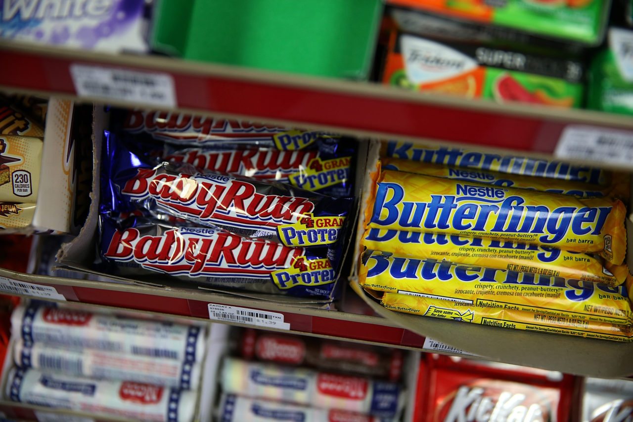 SAN FRANCISCO, CA - FEBRUARY 18: Nestle Butterfinger and Baby Ruth candy bars are displayed on a shelf at a convenience store on February 18, 2015 in San Francisco, California. Nestle USA announced plans to remove all artificial flavors and FDA-certified colors from its entire line of chocolate candy products, including the popular Butterfinger and Baby Ruth candy bars, by the end of 2015.