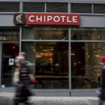 NEW YORK, NEW YORK -- FEBRUARY 8: People walk past a Chipotle restaurant on Broadway in Lower Manhattan on February 8, 2016 in New York City. The Mexican food chain is closing stores for lunch nationwide for a meeting on food safety following a number of E. coli outbreaks. (Photo by Andrew Renneisen/Getty Images)