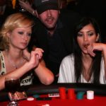 SANTA MONICA, CA - APRIL 12: Socialite Paris Hilton and friend Kim play poker at the Los Angeles Lakers 3rd annual Mirage Las Vegas Casino Night and Bodog Celebrity Poker Invitational benefiting Los Angeles Lakers Youth Foundation at Barker Hangar on April 12, 2006 in Santa Monica, California. (Photo by Vince Bucci/Getty Images for Bodog.Com)