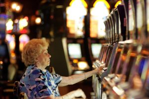 NEW ORLEANS - AUGUST 24: A woman plays a slot machine at Harrah's casino August 24, 2006 in New Orleans, Louisiana. The tourism industry in New Orleans continues to struggle with fewer people visiting the city one year after hurricane Katrina. (Photo by Justin Sullivan/Getty Images)