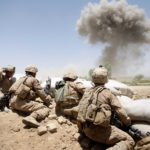 MAIN POSHTEH, AFGHANISTAN - JULY 3: U.S. Marines from 2nd Marine Expeditionary Brigade, RCT 2nd Battalion 8th Marines Echo Co. take cover as a 500 lb bomb explodes on a compound after the Marines took two days of enemy fire from the position on July 3, 2009 in Main Poshteh, Afghanistan. The Marines are part of Operation Khanjari which was launched to take areas in the Southern Helmand Province that Taliban fighters are using as a supply route and to help the local Afghan population prepare for the upcoming presidential elections. (Photo by Joe Raedle/Getty Images)