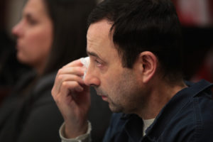 LANSING, MI - JANUARY 17: Larry Nassar wipes a tear as he listens to Carrie Hogan deliver a victim impact statement at his sentencing hearing on January 17, 2018 in Lansing, Michigan. Nassar has pleaded guilty in Ingham County, Michigan, to sexually assaulting seven girls, but the judge is allowing 101 ofl his accusers to speak. Nassar is currently serving a 60-year sentence in federal prison for possession of child pornography.