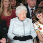 LONDON, ENGLAND - FEBRUARY 20: Queen Elizabeth II sits next to American Vogue editor Anna Wintour (R) and Caroline Rush, chief executive of the British Fashion Council (BFC) (L) as they view Richard Quinn's runway show before presenting him with the inaugural Queen Elizabeth II Award for British Design as she visits London Fashion Week's BFC Show Space on February 20, 2018 in London, United Kingdom.