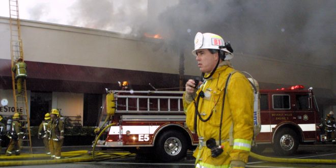 Battalion Chef Cavaglieri talks on the radio during a fire February 27, 2000 in downtown Beverly Hills, CA. A fire broke out at a frame store in the 9400 block of Santa Monica Boulevard shortly before noon. 'The building will be a total loss,' Beverly Hills Fire Chief Clarence Martin said. (Photo by Jason Kirk/Newsmakers)