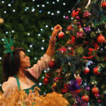 LONDON, ENGLAND - AUGUST 02: An employee hangs a decoration on a tree in the Christmas shop at Selfridges department store on August 2, 2010 in London, England. Selfridges launched its Christmas shop today, 145 days ahead of Christmas Day. The department store expects to see strong sales in the first week of trade last year selling over 1000 baubles in their first week of trade after opening on August 8th. Foreign tourists are thought to be those most likely to take advantage of the early opportunity to take back Christmas gifts. (Photo by Dan Kitwood/Getty Images)