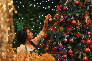 LONDON, ENGLAND - AUGUST 02: An employee hangs a decoration on a tree in the Christmas shop at Selfridges department store on August 2, 2010 in London, England. Selfridges launched its Christmas shop today, 145 days ahead of Christmas Day. The department store expects to see strong sales in the first week of trade last year selling over 1000 baubles in their first week of trade after opening on August 8th. Foreign tourists are thought to be those most likely to take advantage of the early opportunity to take back Christmas gifts. (Photo by Dan Kitwood/Getty Images)
