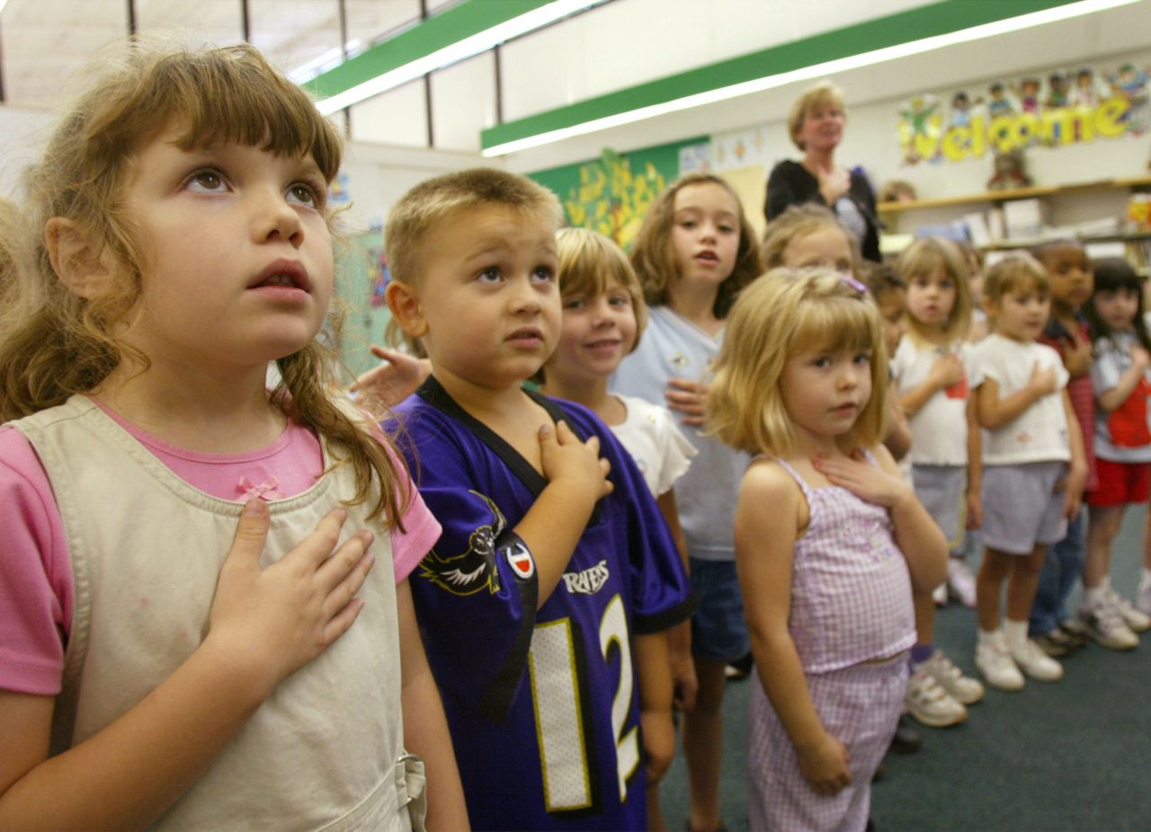 SUNDERLAND, MD - SEPTEMBER 17: Sarah Henderson (L) and children from Mrs. Morrow's kindergarden class at Sunderland Elementry school recite the Pledge of Allegiance September 17, 2002 in Sunderland, Maryland. The children were participating in the "The Pledge Across America", a national recitation of the Pledge of Allegiance. (Photo by Mark Wilson/Getty Images)