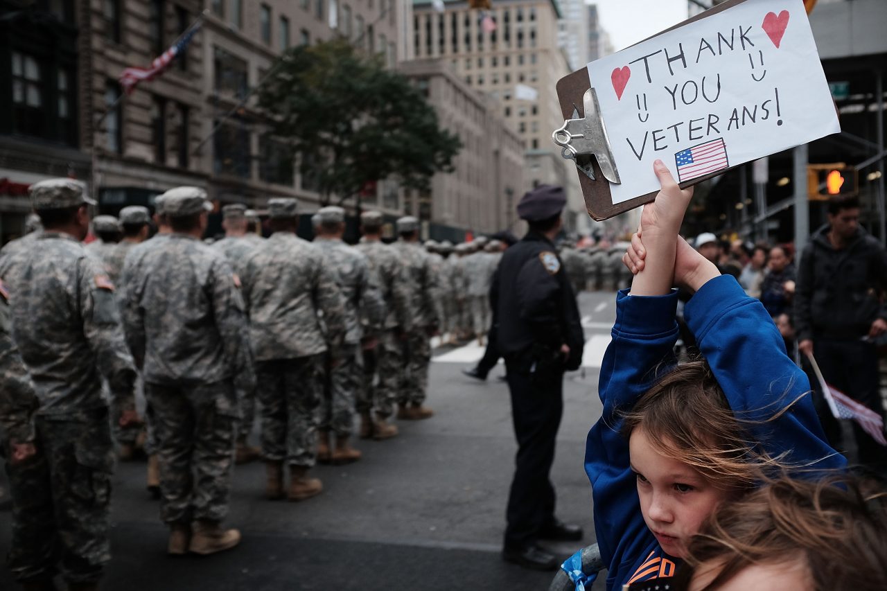 NEW YORK, NY - NOVEMBER 11: Gavin Kinney (9) holds up a sign thanking veterans at the nation's largest Veterans Day Parade in New York City on November 11, 2015 in New York City. Known as "America's Parade" it features over 20,000 participants, including veterans of numerous eras, military units, businesses and high school bands and civic and youth groups. (Photo by Spencer Platt/Getty Images)