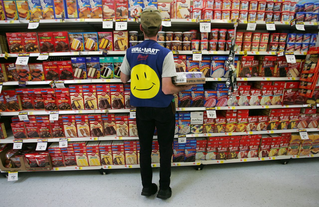 TROY, OH - MAY 11: An employee restocks a shelf in the grocery section of a Wal-Mart Supercenter May 11, 2005 in Troy, Ohio. Wal-Mart, America's largest retailer and the largest company in the world based on revenue, has evolved into a giant economic force for the U.S. economy. With growth, the company continues to weather criticism of low wages, anti-union policies as well as accusations that it has homogenized America's retail economy and driven traditional stores and shops out of business. (Photo by Chris Hondros/Getty Images)