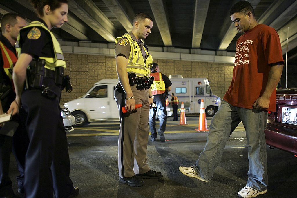 MIAMI - DECEMBER 15: Trooper, David Casillas, (C) from the Florida Highway Patrol conducts a field sobriety test at a DUI checkpoint December 15, 2006 in Miami, Florida. The city of Miami, with the help of other police departments, will be conducting saturation patrols and setting up checkpoints during the holiday period looking to apprehend drivers for impaired driving and other traffic violations. (Photo by Joe Raedle/Getty Images)