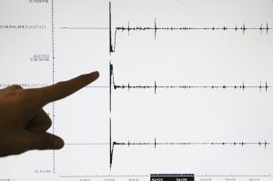 NORTH SULAWESI, INDONESIA - JANUARY 24: A Meteorology and Geophysics Agency (BMG) officer points to a screen graphic at the BMG office of a 6.5-magnitude earthquake that struck North Sulawesi province on January 21, 2007 on the island of Sulawesi, Indonesia. Many aftershocks have been recorded since an initial earthquake that caused panic but no serious damage. An earthquake with a magnitude of 5.3 has shaken Indonesia's North Sulawesi province again on January 24, 2007 but there have been no immediate reports of any damage. (Photo by Dimas Ardian/Getty Images)