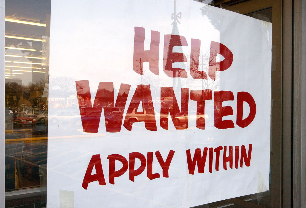 MOUNT PROSPECT, IL - DECEMBER 5: A sign that reads "Help Wanted Apply Within" is seen hanging in a window of a beverage store December 5, 2003 in Mount Prospect, Illinois. The Bureau of Labor Statistics of the U.S. Department of Labor released the November Employment Report today stating employment continued to trend up in November and the unemployment rate, at 5.9 percent, was essentially unchanged from October. Non-farm payroll employment rose slightly over the month to 57,000. (Photo by Tim Boyle/Getty Images)