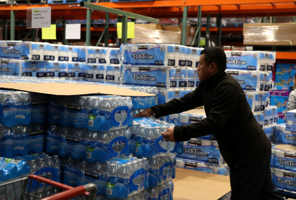 NOVATO, CALIFORNIA - MARCH 14: A customer grabs a case of drinking water at a Costco store on March 14, 2020 in Novato, California. Some Americans are stocking up on food, toilet paper, water and other items after the World Health Organization (WHO) declared Coronavirus (COVID-19) a pandemic. (Photo by Justin Sullivan/Getty Images)