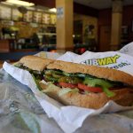 MIAMI, FL - OCTOBER 21: A Subway sandwich is seen in a restaurant as the company announced a settlement over a class-action lawsuit that alleged that Subway engaged in deceptive marketing for its 6-inch and 12-inch sandwiches and served customers less food than they were paying for on October 21, 2015 in Miami, Florida. While it denies the claims, Subway said that franchisees would be required to have a measurement tool in stores to make sure loaves are 12-inches. (Photo by Joe Raedle/Getty Images)