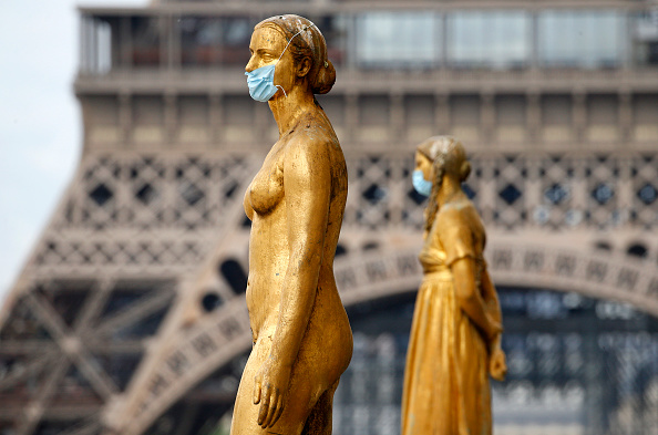 PARIS, FRANCE - MAY 03: Golden statues at the Trocadero square near the Eiffel Tower wear protectiv...
